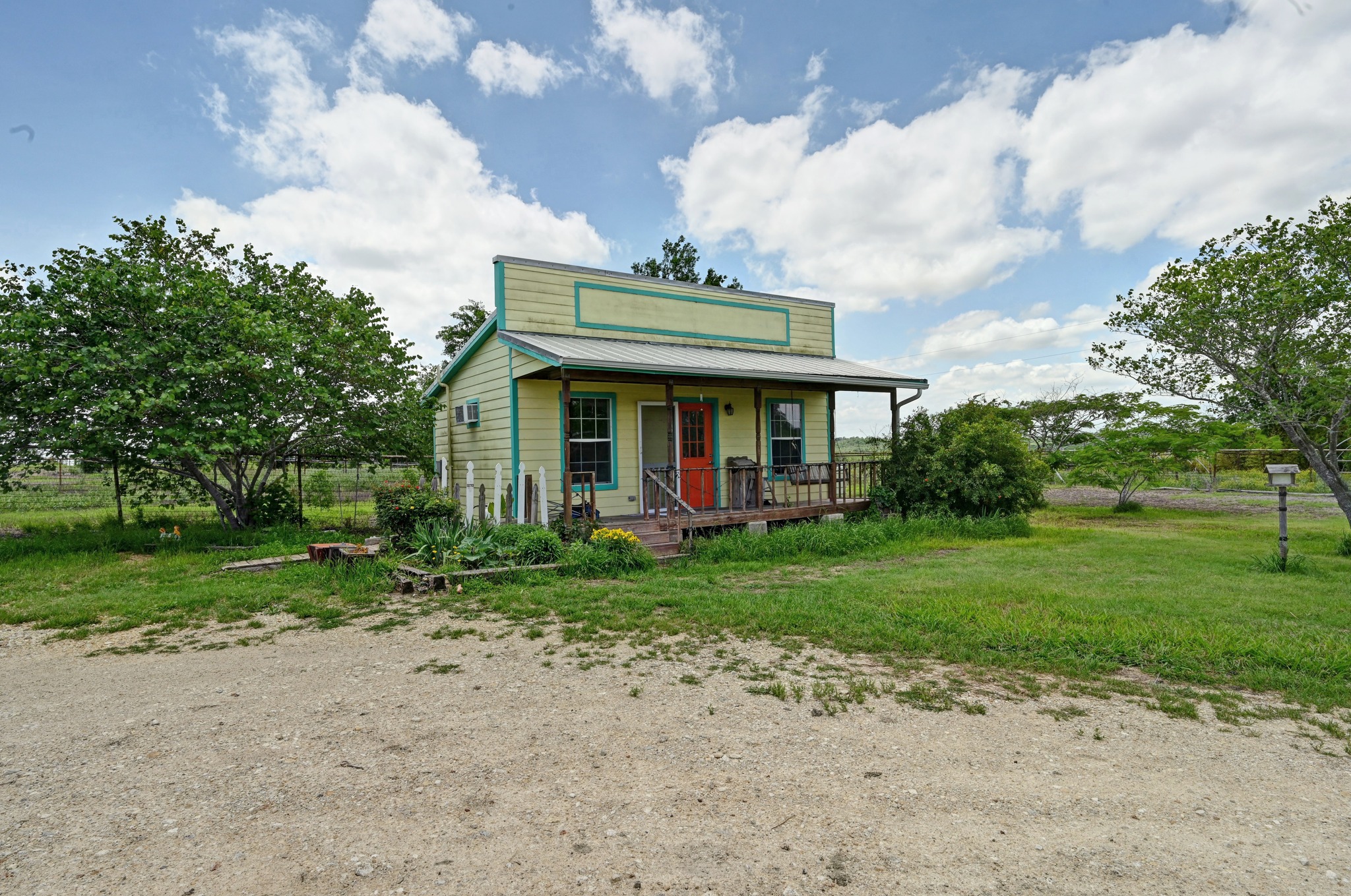 410 Simmons Family Farm Road Lockhart, TX 78644 - Photo 33 of 40 a front view of a house with garden