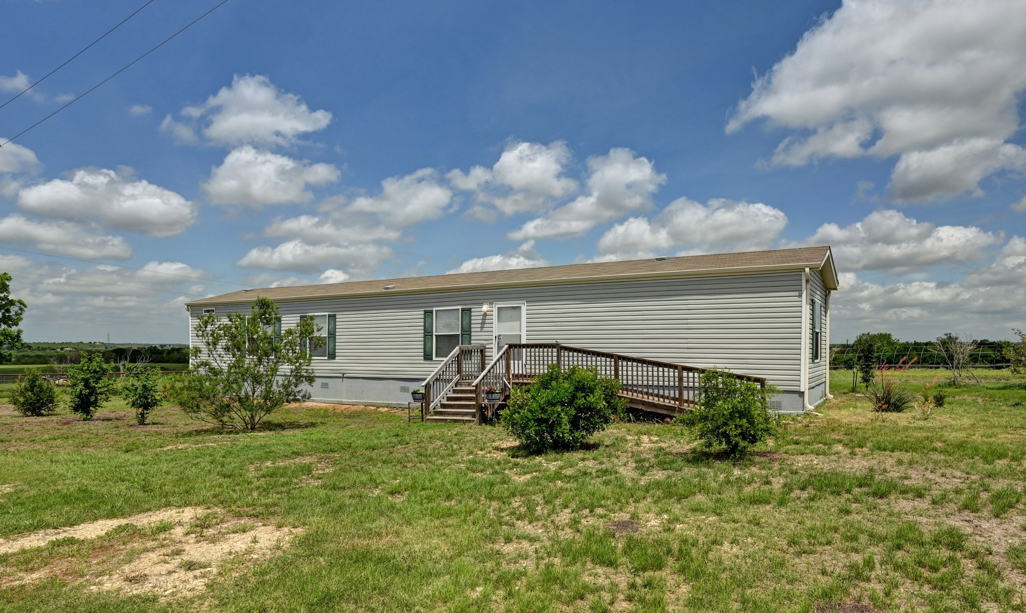 410 Simmons Family Farm Road Lockhart, TX 78644 - Photo 35 of 40 a view of a house with garden and a yard