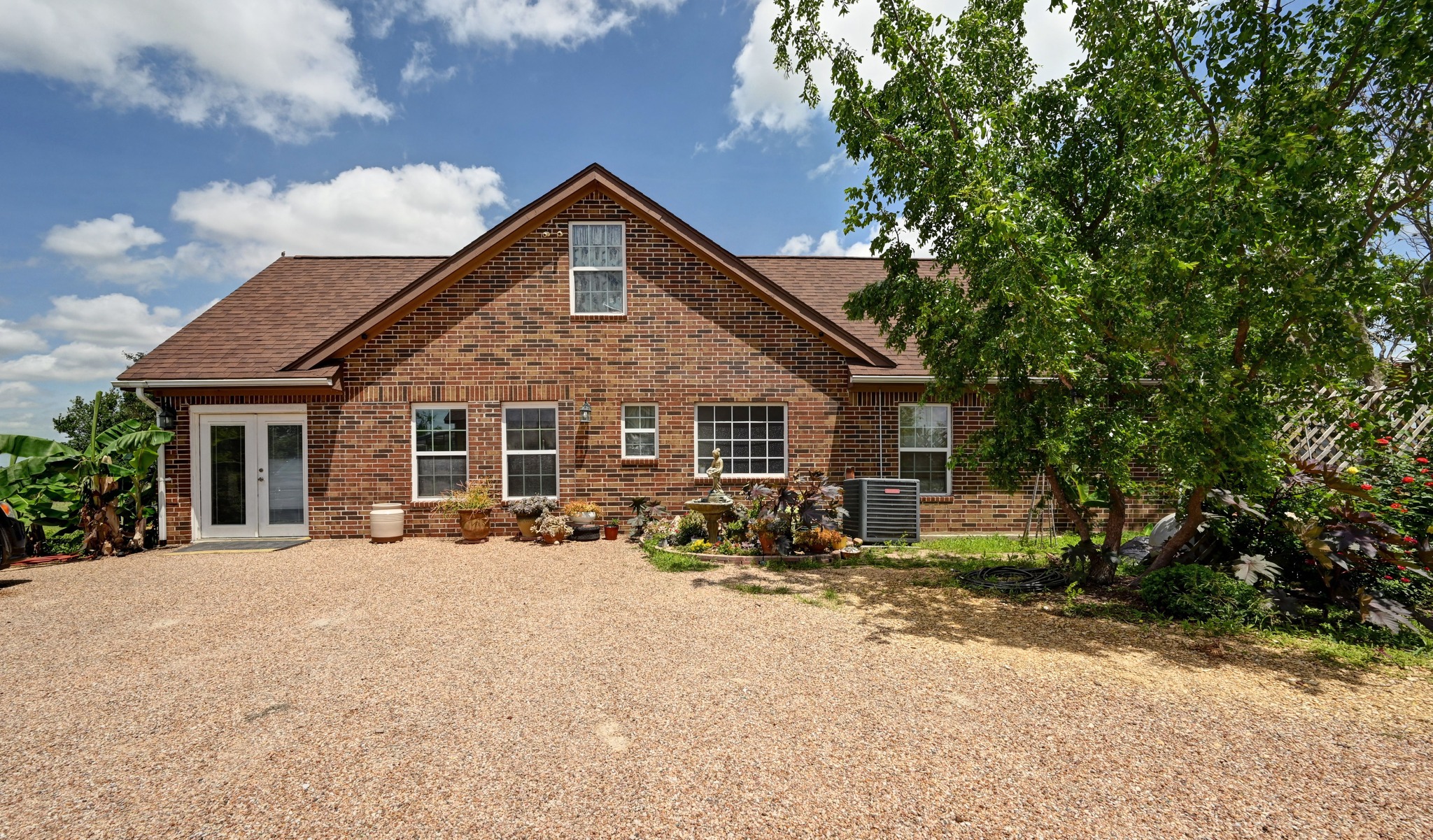410 Simmons Family Farm Road Lockhart, TX 78644 - Photo 5 of 40 a view of a house with yard and sitting area