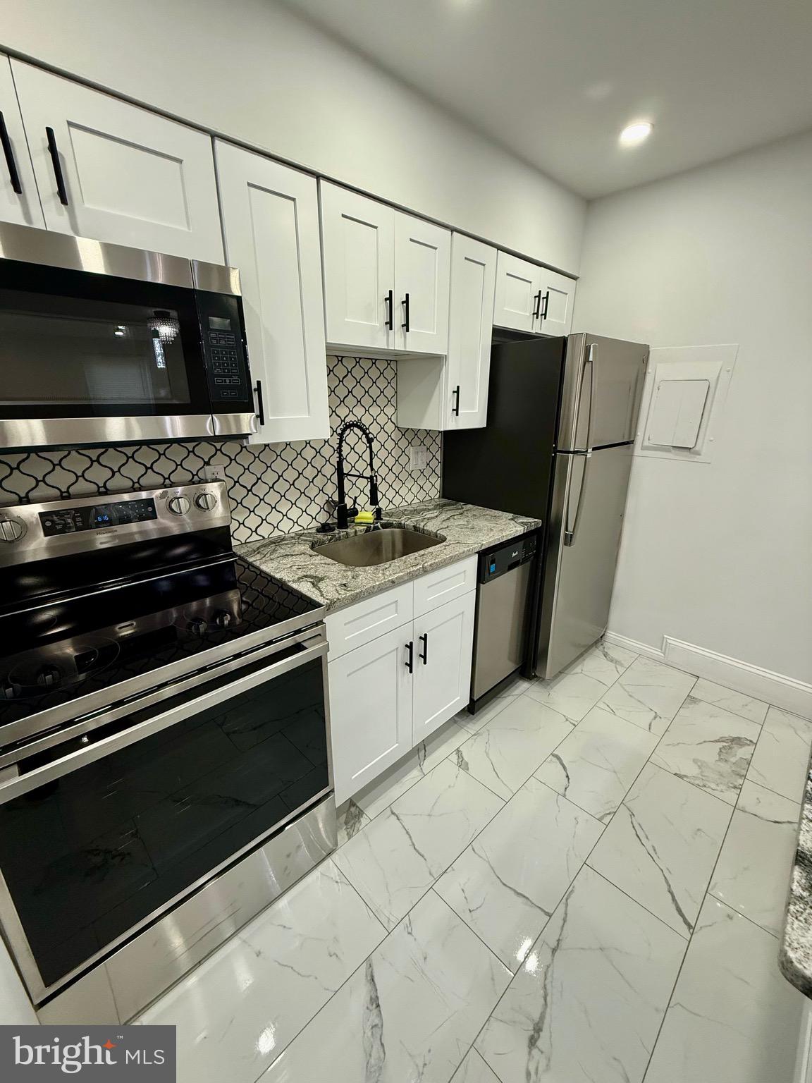 42 Conshohocken State Road, Unit 8A Bala Cynwyd, PA 19004 - Photo 13 of 15 a kitchen with stainless steel appliances granite countertop a stove and a refrigerator