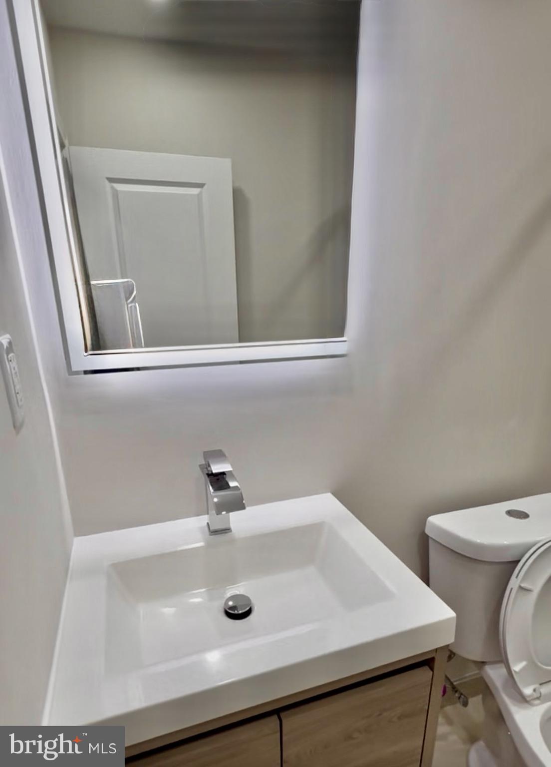 42 Conshohocken State Road, Unit 8A Bala Cynwyd, PA 19004 - Photo 15 of 15 a bathroom with a sink a toilet and mirror