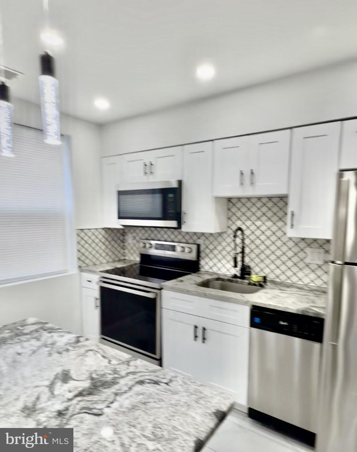 42 Conshohocken State Road, Unit 8A Bala Cynwyd, PA 19004 - Photo 7 of 15 a kitchen with stainless steel appliances granite countertop a sink stove and refrigerator