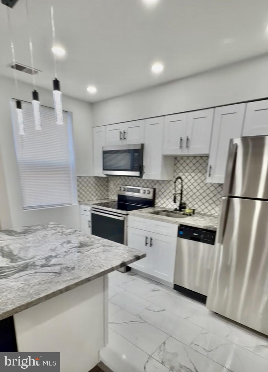 42 Conshohocken State Road, Unit 8A Bala Cynwyd, PA 19004 - Photo 9 of 15 a kitchen with granite countertop a refrigerator and a sink