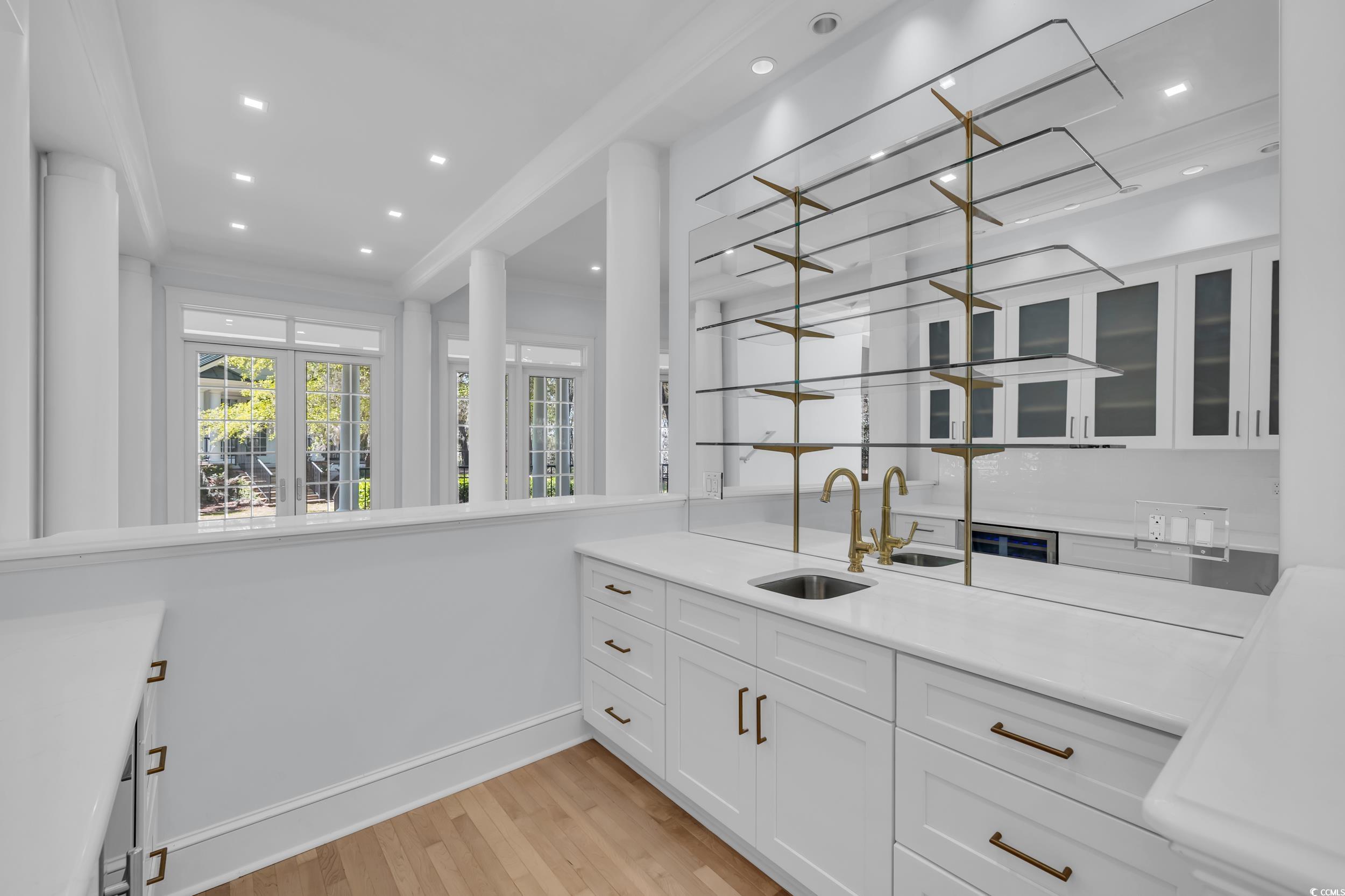 511 Rice Bluff Road Pawleys Island, SC 29585 - Photo 11 of 40 custom cabinetry, a quartz countertop, Hoshizaki ice-maker, wine cooler and glass shelving for glassware