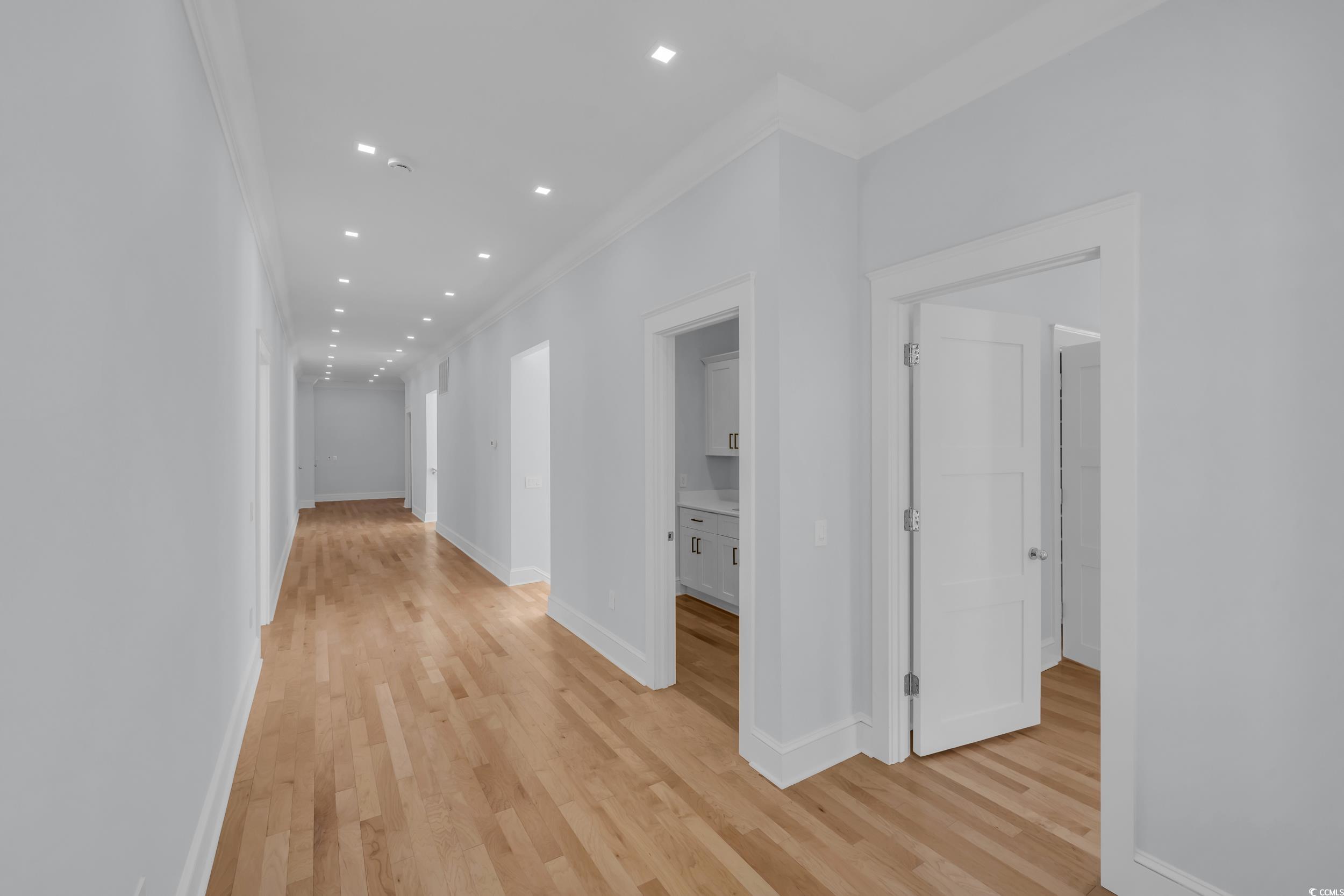 511 Rice Bluff Road Pawleys Island, SC 29585 - Photo 17 of 40 Upstairs Corridor with wood floors, baseboards, recessed lighting, and ornamental molding