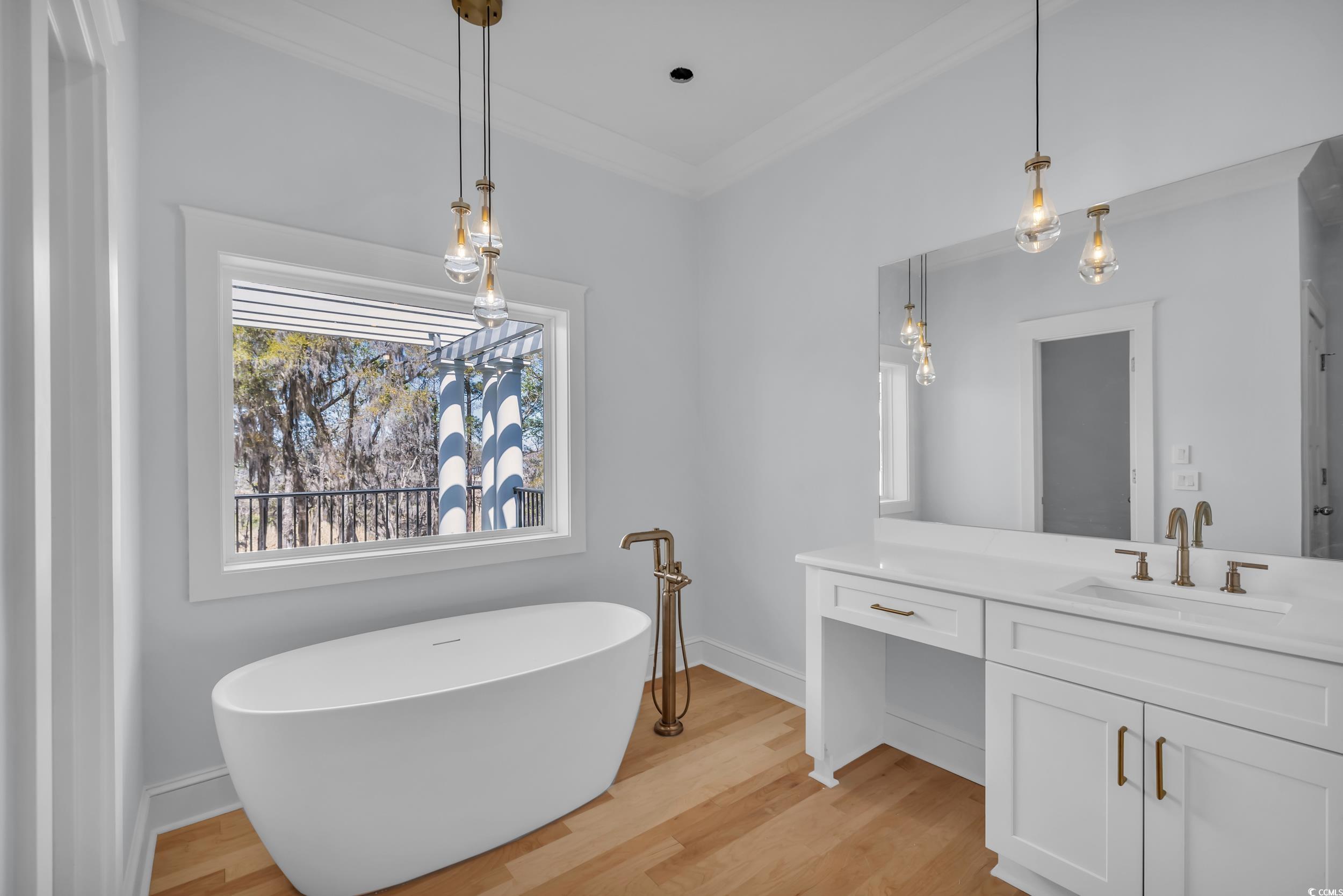511 Rice Bluff Road Pawleys Island, SC 29585 - Photo 22 of 40 Full bathroom with double vanity, a freestanding tub, crown molding, tiled-steam shower, His/Her walk-in closets