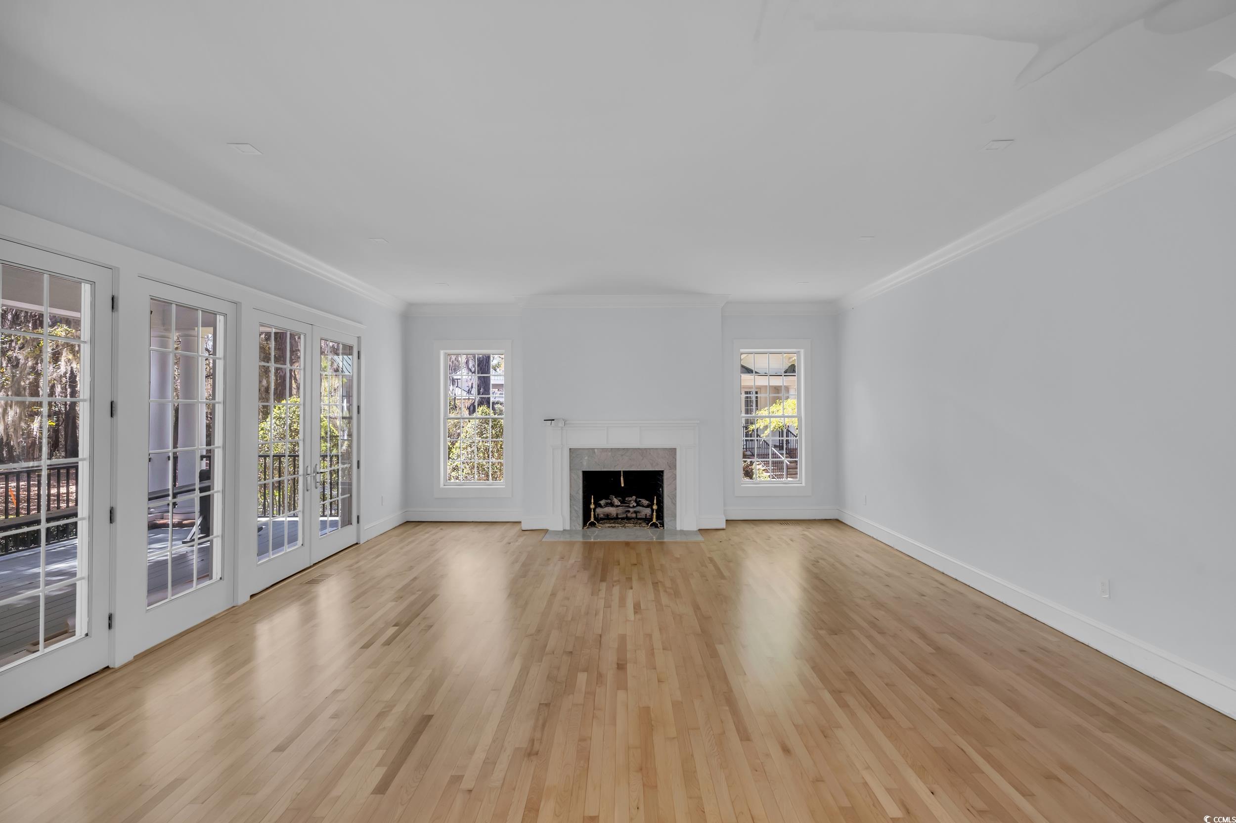 511 Rice Bluff Road Pawleys Island, SC 29585 - Photo 7 of 40 living room with hardwood floorings, fireplace with gas logs
