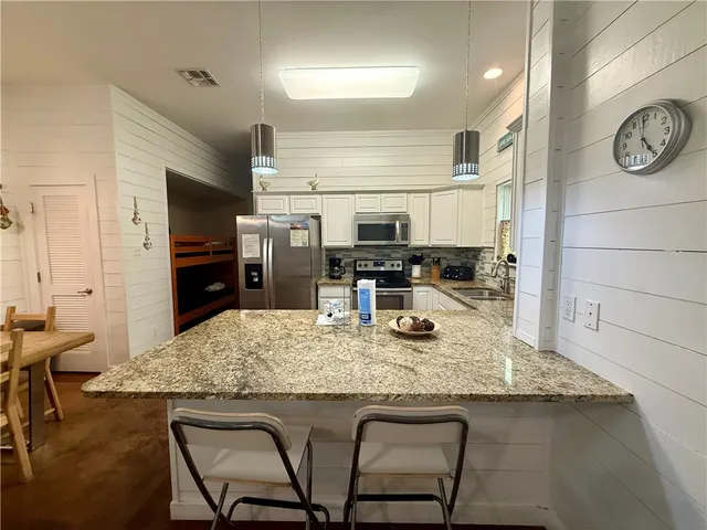 a kitchen with a table and chairs in it