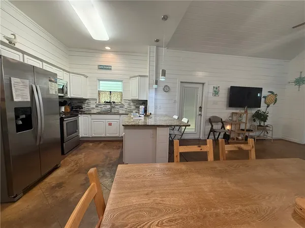 a kitchen with a sink stainless steel appliances and cabinets