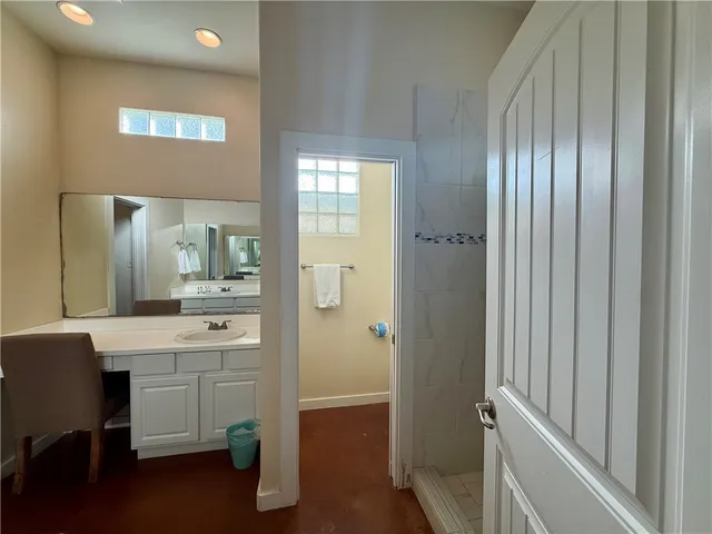 a bathroom with a sink a mirror and a shower