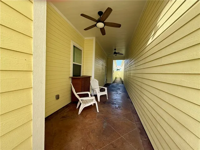 a balcony with table and chairs and wooden floor
