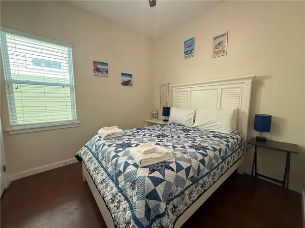 a bedroom with a bed and window