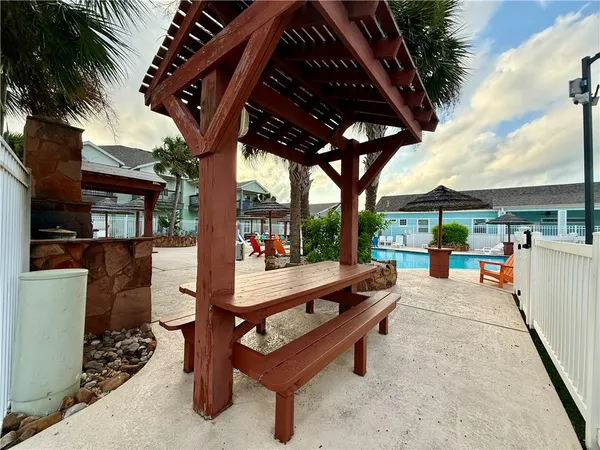 a view of a patio with a table and chairs