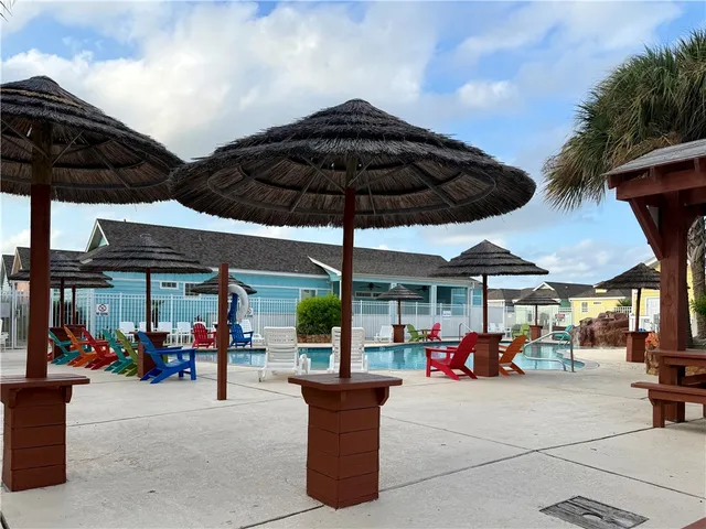 a view of the patio with a table and chairs under an umbrella