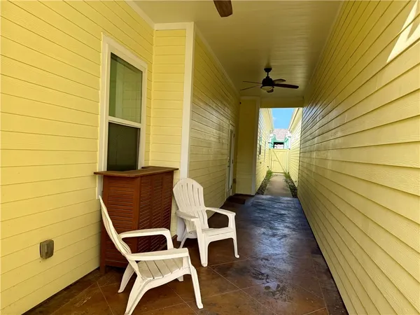 a balcony with table and chairs