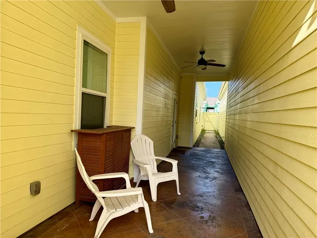 a balcony with table and chairs