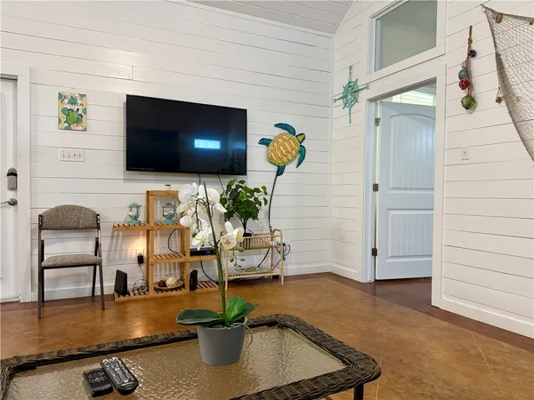 a living room with furniture and a flat screen tv