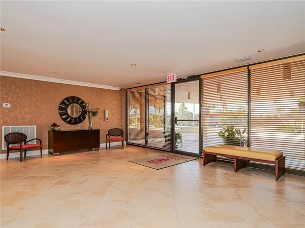 a living room with furniture and large windows