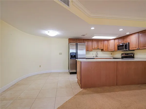 a kitchen with stainless steel appliances granite countertop a refrigerator sink and cabinets