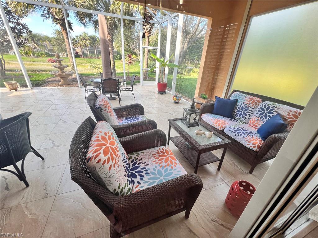 7651 Hernando Court Naples, FL 34114 - Photo 12 of 37 a living room with furniture and a large window