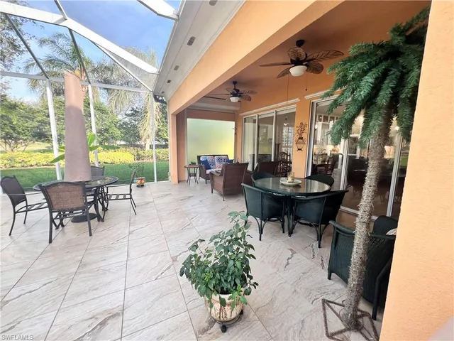 a view of a patio with dining table and chairs