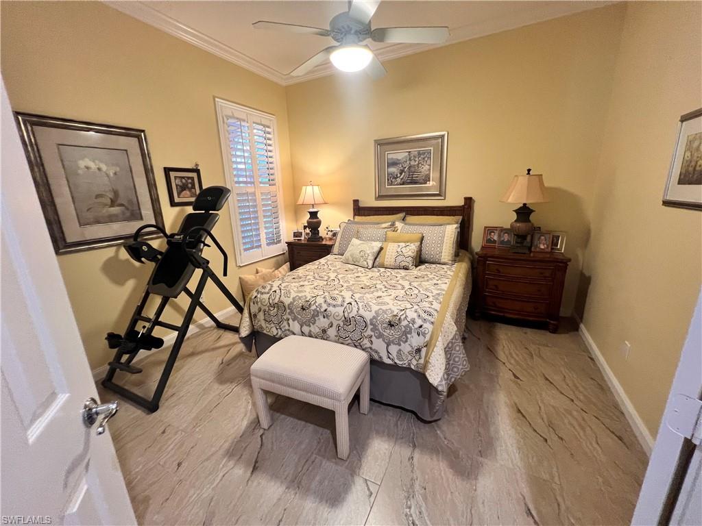 7651 Hernando Court Naples, FL 34114 - Photo 23 of 37 a bedroom with furniture and a chandelier
