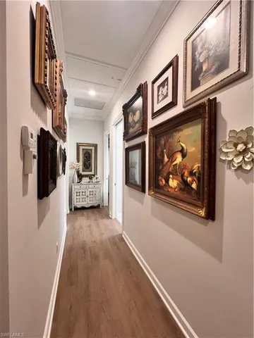a view of a hallway with wooden floor and fireplace