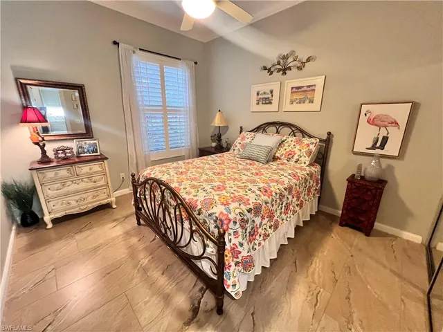 a bedroom with bed and a window