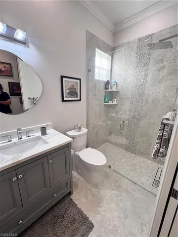 a bathroom with a sink a toilet and mirror