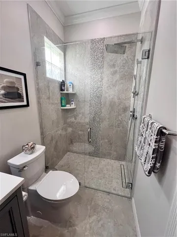 a bathroom with a toilet sink and shower
