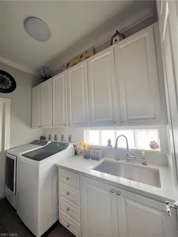 a kitchen with a sink cabinets and window