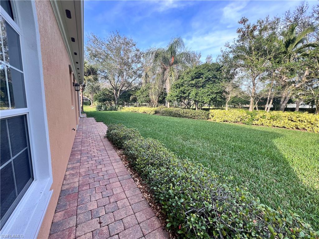 7651 Hernando Court Naples, FL 34114 - Photo 30 of 37 a view of a pathway with a yard