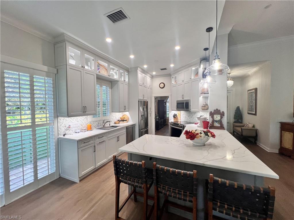 7651 Hernando Court Naples, FL 34114 - Photo 3 of 37 a large kitchen with a table and chairs