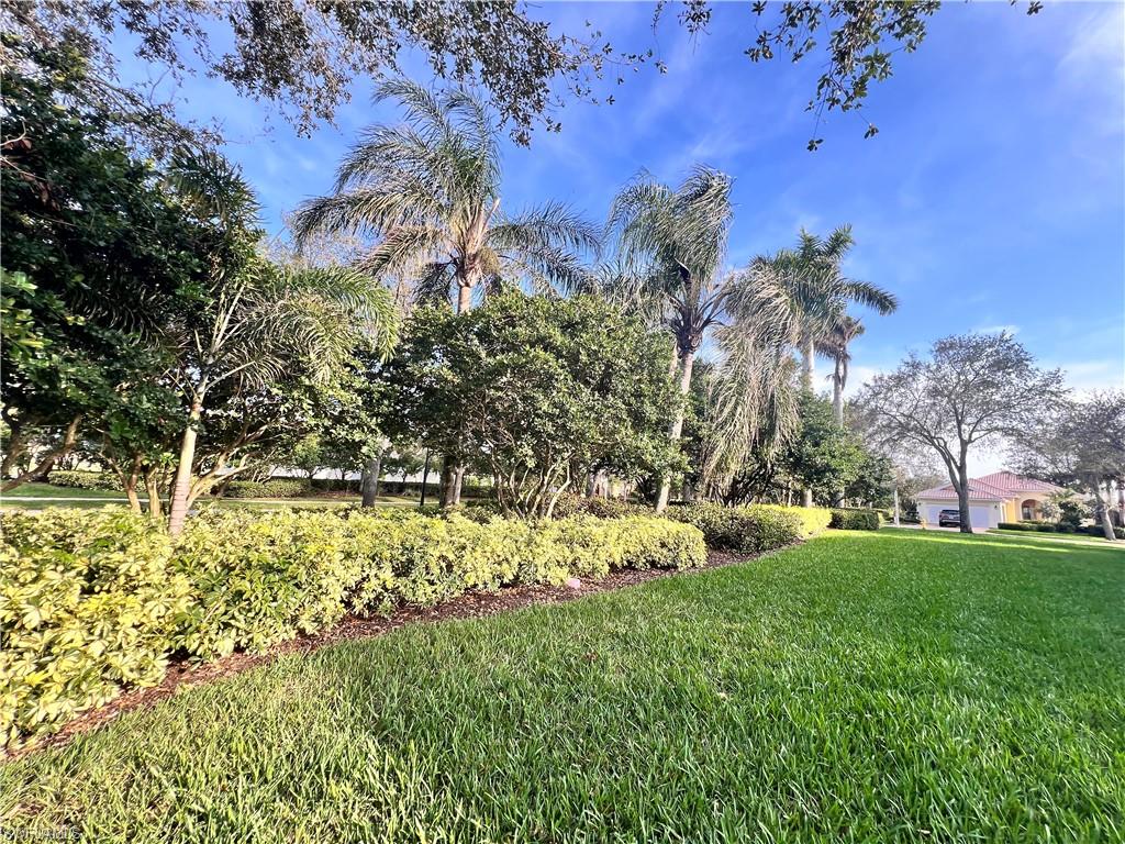 7651 Hernando Court Naples, FL 34114 - Photo 33 of 37 a view of a garden with a building in background