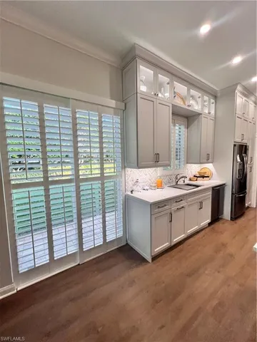 a bathroom with a double vanity sink and large mirror