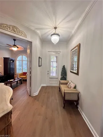 a living room with furniture a flat screen tv and a window