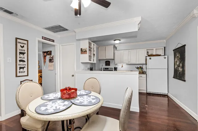 a kitchen with stainless steel appliances granite countertop a dining table and chairs