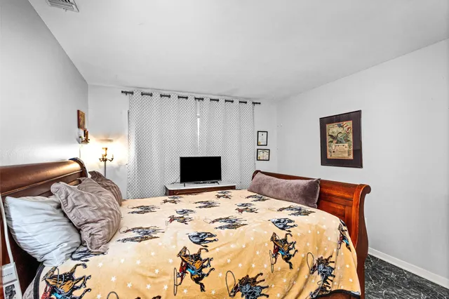 a bedroom with a bed and a fireplace