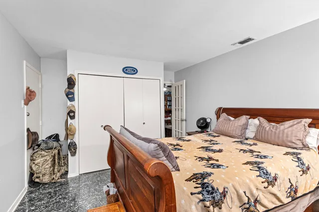 a bedroom with a bed and a dresser