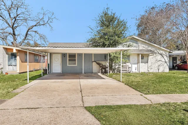 a front view of a house with a garden and patio