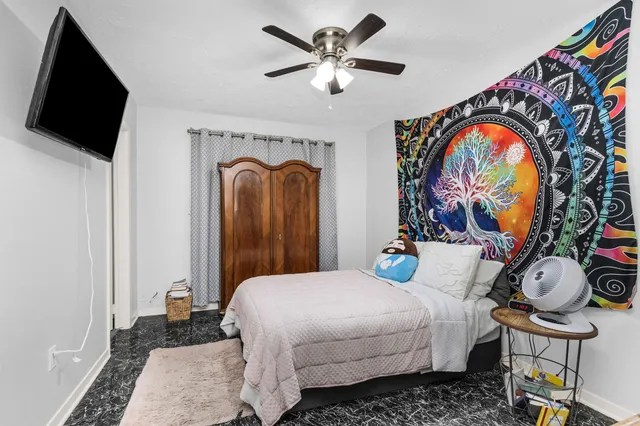 a bedroom with a bed and dresser with mirror