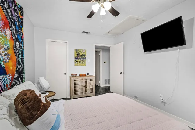 a bedroom with a bed and a flat screen tv