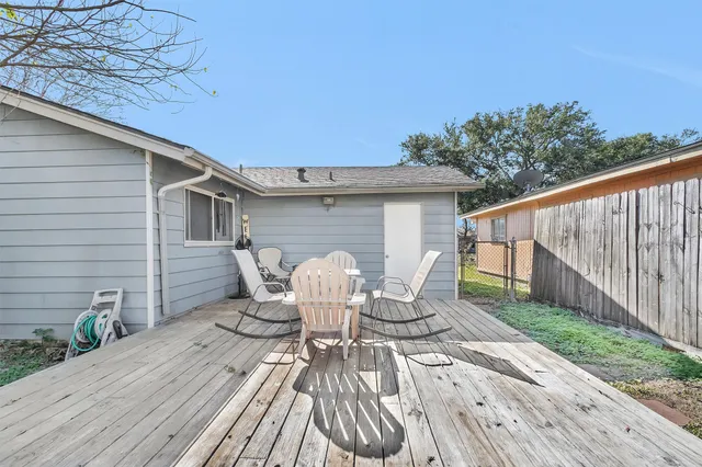 a view of a patio with table and chairs and wooden floor
