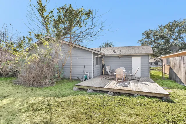 a view of a chair and table in backyard