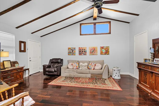 a bedroom with furniture and a rug