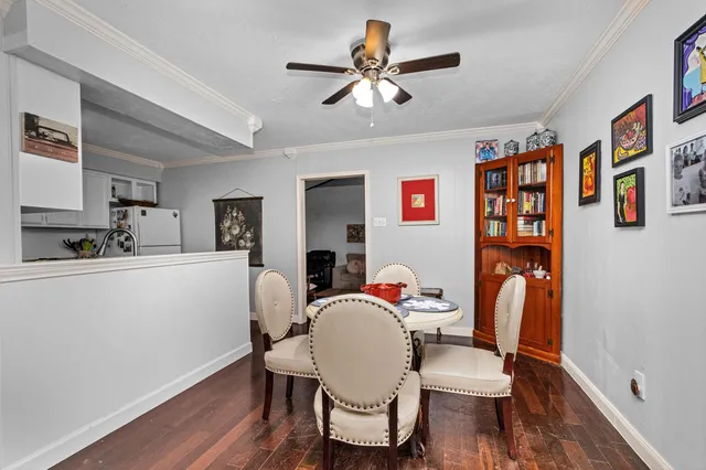 a dining room with furniture and wooden floor