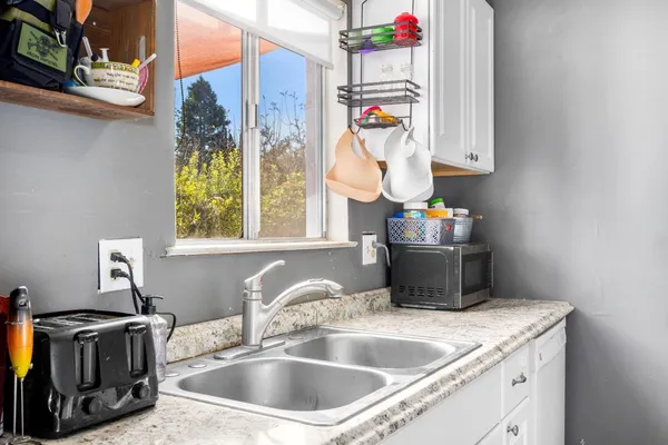 a kitchen with a sink and a stove top oven