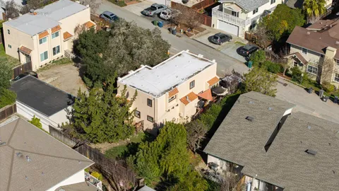 an aerial view of a house with a yard