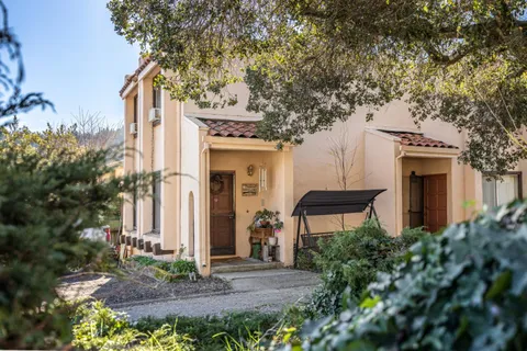 a front view of a house with a garden