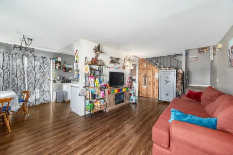 a living room with lots of furniture and a flat screen tv